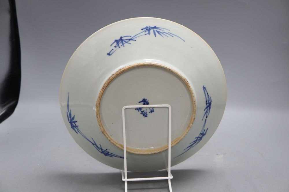 A 19th century Chinese blue and white prunus pattern dish, Kangxi mark, diameter 27cm